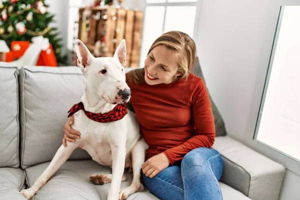 Young Caucasian Woman Smiling Confident Hugging Dog Sitting Christmas Tree — Stock Photo, Image