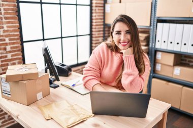 Young beautiful hispanic woman ecommerce business worker using laptop working at office