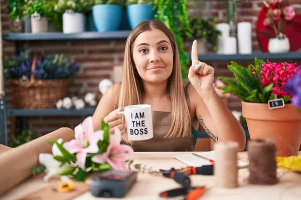 Young Blonde Woman Working Florist Shop Holding Boss Cup Smiling — Stockfoto