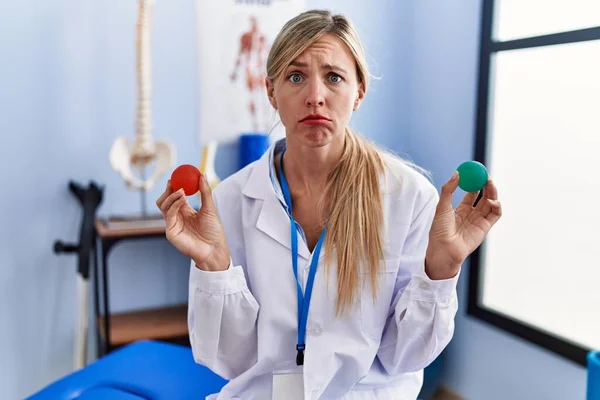 Beautiful Woman Holding Strength Ball Hand Rehabilitation Skeptic Nervous Frowning — Stok fotoğraf