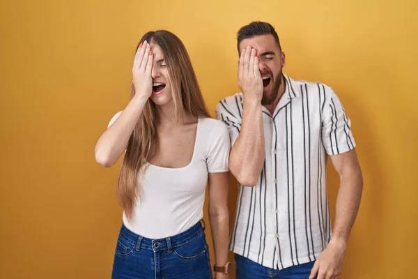 Young Couple Standing Yellow Background Yawning Tired Covering Half Face — Foto Stock
