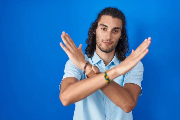 Young Hispanic Man Standing Blue Background Rejection Expression Crossing Arms — Zdjęcie stockowe