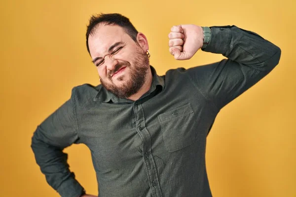 Size Hispanic Man Beard Standing Yellow Background Stretching Back Tired — Stockfoto
