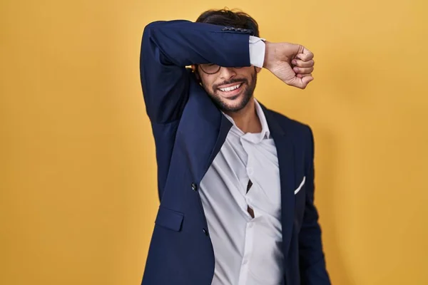 Handsome Latin Man Standing Yellow Background Covering Eyes Arm Smiling — 图库照片