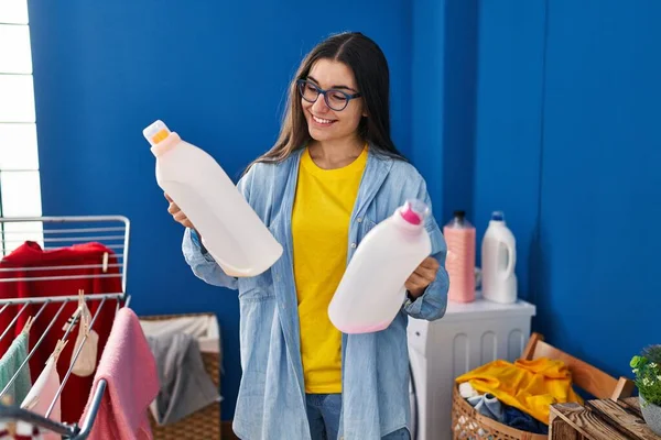 Young Hispanic Woman Smiling Confident Holding Detergent Bottles Laundry Room — Fotografia de Stock