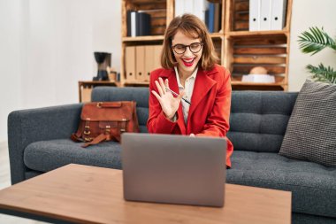 Young caucasian woman psychologist having online consultation at psychology center clipart