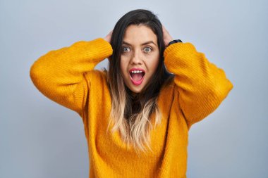 Tecrit edilmiş arka planda duran genç İspanyol kadın deliydi ve elleri başının üstündeydi, korkmuş ve ağzı açık şok geçirmekten korkuyordu. 