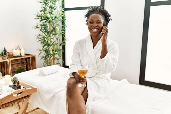 Afroamerikanerin Bademantel Trinkt Champagner Und Redet Schönheitssalon Auf Dem Smartphone — Stockfoto