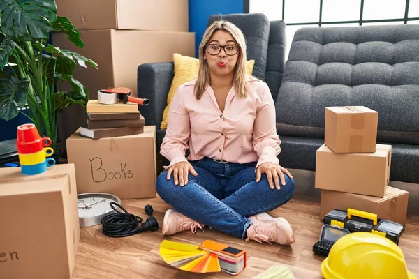Young Hispanic Woman Moving New Home Sitting Floor Puffing Cheeks — Stock Photo, Image