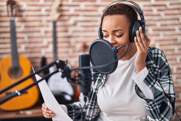 African american woman musician singing song at music studio