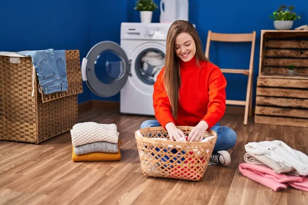 Young Blonde Woman Folding Clothes Sitting Floor Laundry Room — Stock fotografie