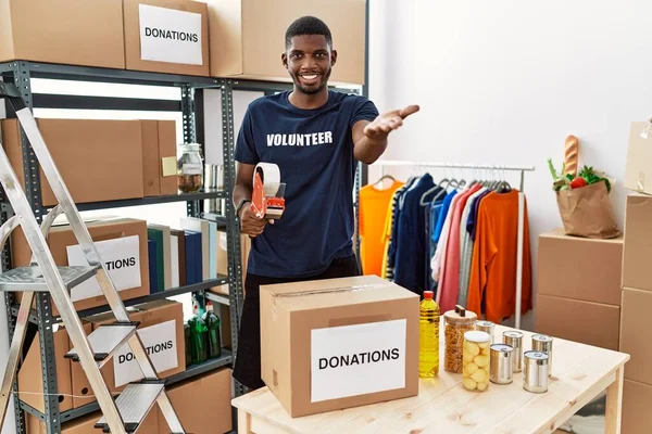 Jonge Afro Amerikaanse Vrijwilliger Verpakking Donaties Doos Voor Liefdadigheid Glimlachend — Stockfoto