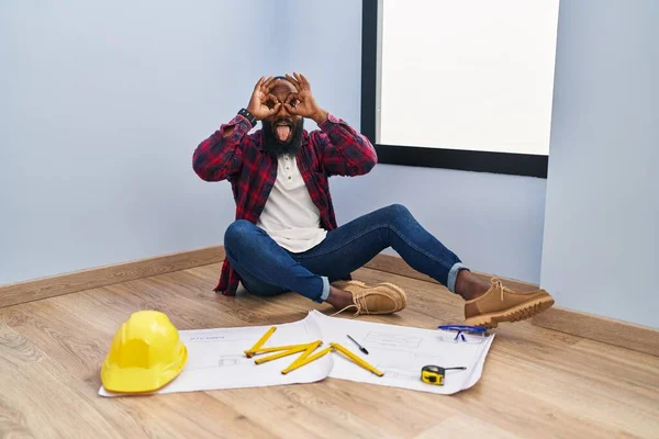 African American Man Sitting Floor New Home Looking Blueprints Doing —  Fotos de Stock