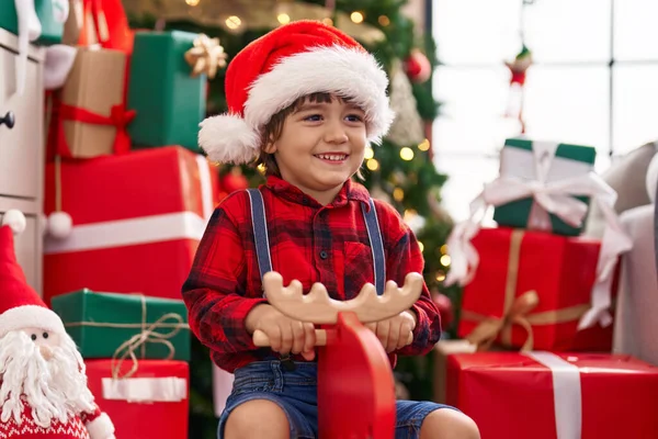 Adorable Toddler Smiling Confident Playing Reindeer Rocking Christmas Tree Home — Stock Photo, Image
