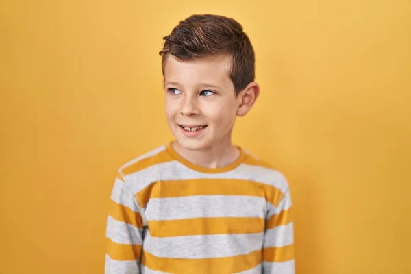 Young Caucasian Kid Standing Yellow Background Looking Away Side Smile — Foto Stock
