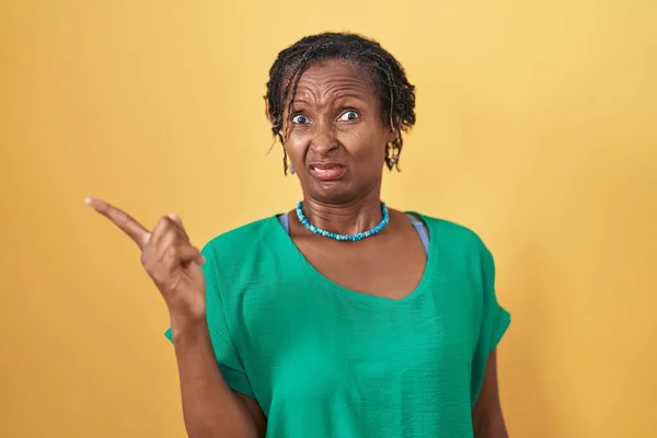 African Woman Dreadlocks Standing Yellow Background Pointing Aside Worried Nervous — Fotografia de Stock