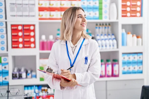Young Woman Pharmacist Smiling Confident Writing Document Pharmacy — Foto de Stock