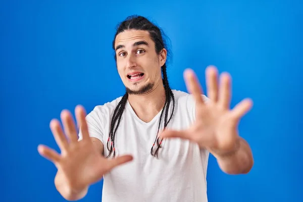 Hispanic Man Long Hair Standing Blue Background Afraid Terrified Fear —  Fotos de Stock