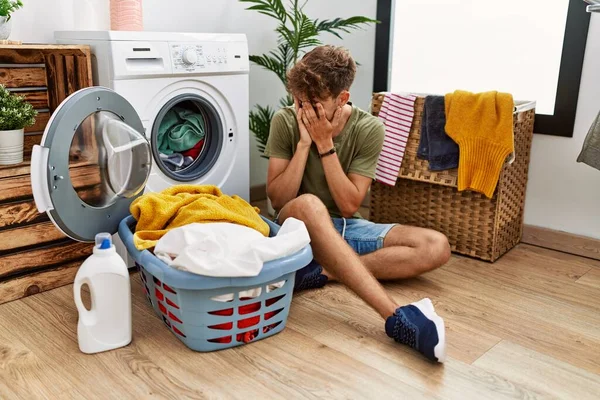 Young Caucasian Man Putting Dirty Laundry Washing Machine Sad Expression — Fotografia de Stock
