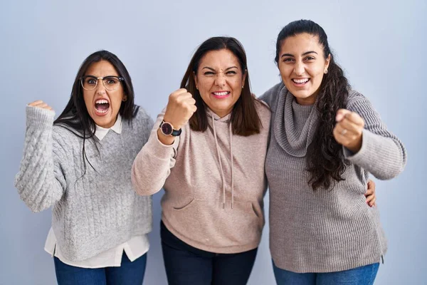 Mother Two Daughters Standing Blue Background Angry Mad Raising Fist — Stockfoto