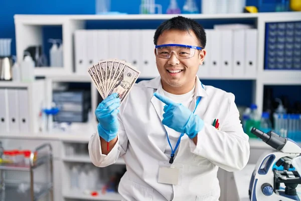 Young Chinese Man Working Scientist Laboratory Holding Money Smiling Happy — Stockfoto
