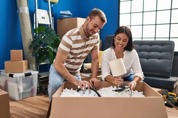 Man Woman Couple Smiling Confident Unboxing Package New Home — Fotografia de Stock
