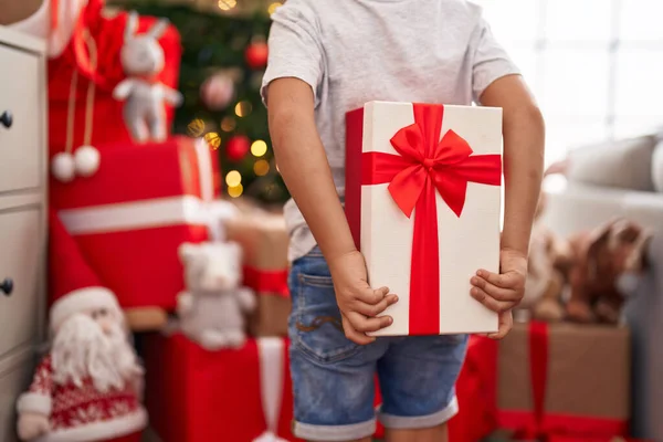 Adorable Toddler Holding Gift Standing Christmas Tree Home — Stock Photo, Image