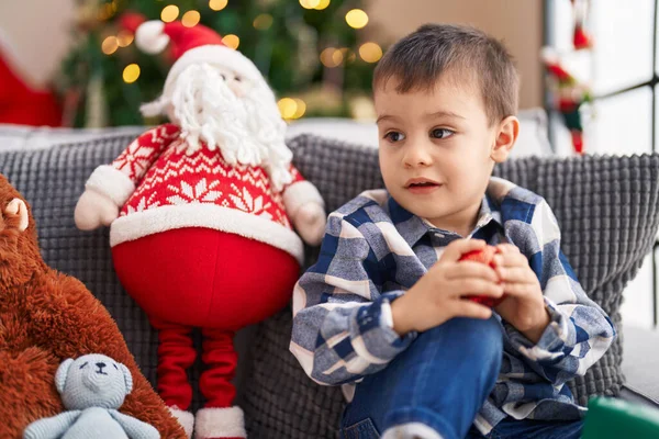 Adorable Toddler Holding Decoration Ball Sitting Sofa Christmas Tree Home — Stock Photo, Image