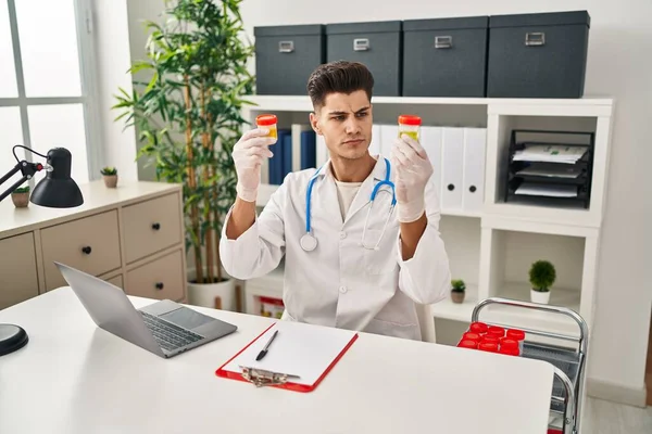 Young Hispanic Man Wearing Doctor Uniform Analysing Urine Test Tubes — ストック写真