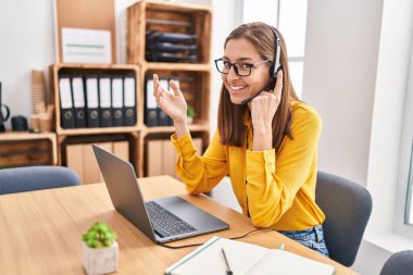 Young woman call center agent working at office