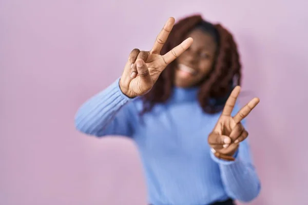 African Woman Standing Pink Background Smiling Tongue Out Showing Fingers — Stock Photo, Image