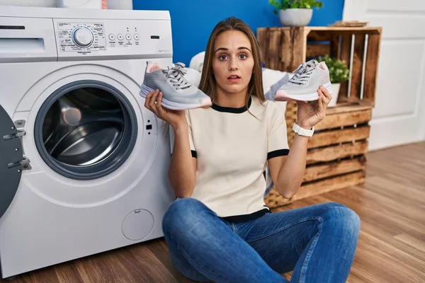 Young Woman Putting Sneakers Washing Machine Clueless Confused Expression Doubt — ストック写真