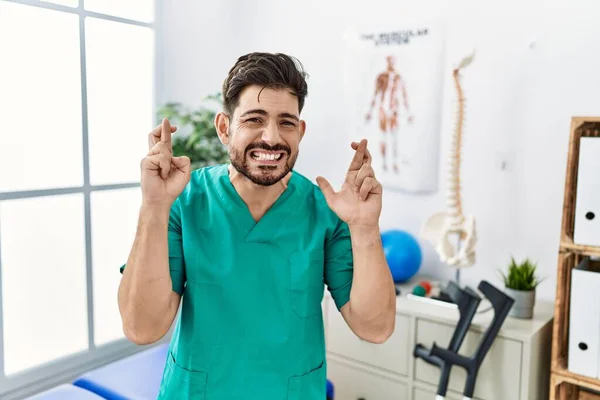Young Man Beard Working Pain Recovery Clinic Gesturing Finger Crossed — Stok fotoğraf