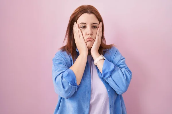 Young Hispanic Woman Red Hair Standing Pink Background Tired Hands — Stockfoto