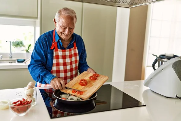 Senior Man Pouring Tomato Frying Pan Kitchen — Stock Photo, Image