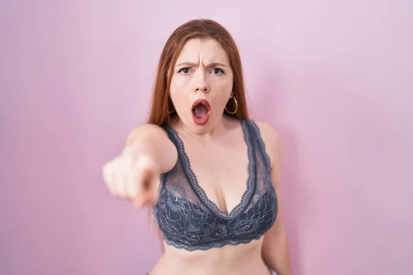 Redhead Woman Wearing Lingerie Pink Background Pointing Displeased Frustrated Camera —  Fotos de Stock