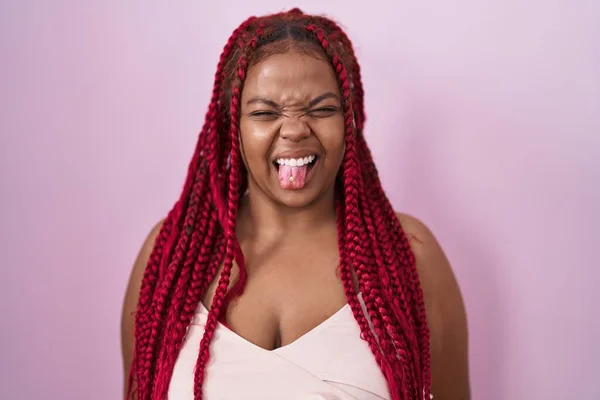 African American Woman Braided Hair Standing Pink Background Sticking Tongue — Fotografia de Stock