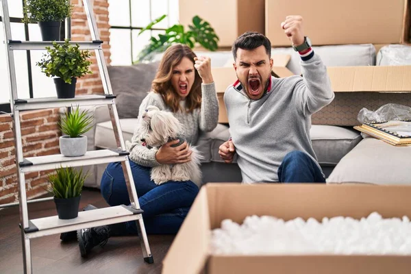 Young Hispanic Couple Sitting Floor New Home Log Annoyed Frustrated — Stockfoto