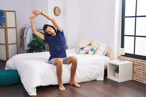 Young Hispanic Man Waking Stretching Arms Bedroom — Stock Photo, Image