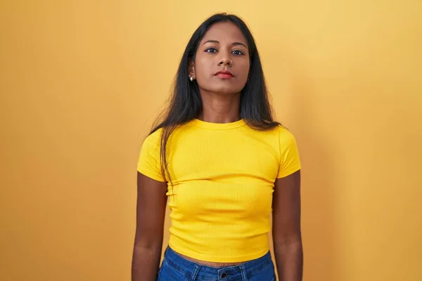 Young Indian Woman Standing Yellow Background Relaxed Serious Expression Face — Zdjęcie stockowe