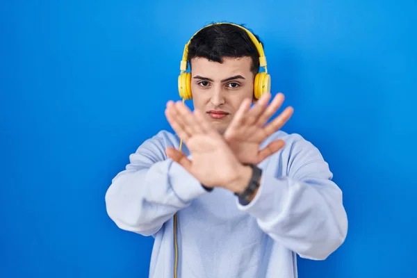 Non Binary Person Listening Music Using Headphones Rejection Expression Crossing — Stock Photo, Image