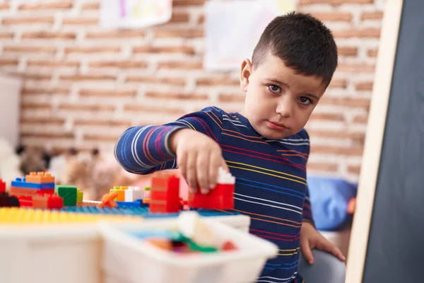 Adorable Hispanic Toddler Playing Construction Blocks Sitting Table Kindergarten — Stockfoto