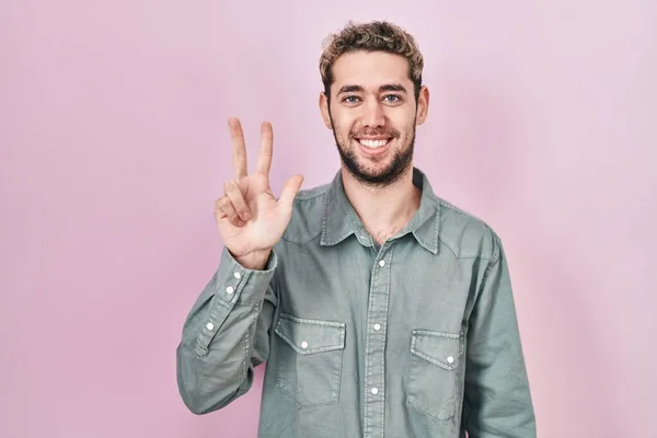 Hispanic Man Beard Standing Pink Background Showing Pointing Fingers Number — Stockfoto