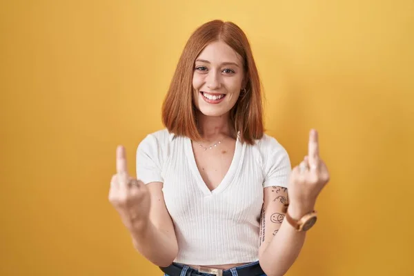 Young Redhead Woman Standing Yellow Background Showing Middle Finger Doing — Foto de Stock