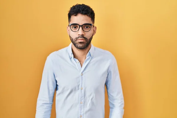 Hispanic Man Beard Standing Yellow Background Relaxed Serious Expression Face — Stock Photo, Image