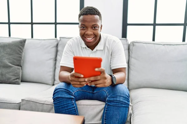 Young African Man Using Touchpad Device Home — Stock fotografie