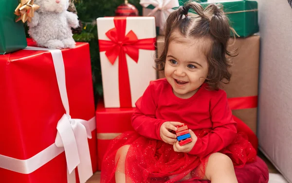 Adorable Hispanic Girl Holding Construction Blocks Sitting Floor Christmas Gifts — Stock Photo, Image