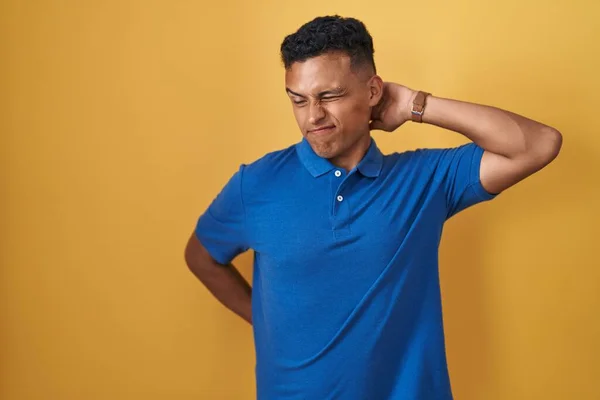 Young Hispanic Man Standing Yellow Background Suffering Neck Ache Injury — Stok fotoğraf