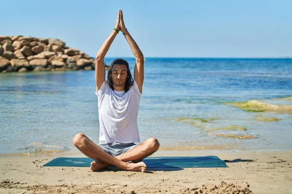 Young Hispanic Man Doing Yoga Exercise Sitting Sand Beach — Stockfoto