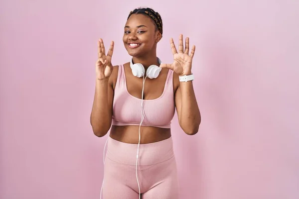 African American Woman Braids Wearing Sportswear Headphones Showing Pointing Fingers — Photo